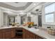 Large bathroom with double sinks, elegant wood cabinets and plenty of natural light at 2174 Kent Ave, Clearwater, FL 33764