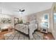 Bright bedroom featuring stylish wrought iron bed and warm, inviting decor, ceiling fan and rug at 2174 Kent Ave, Clearwater, FL 33764