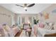 Adorable bedroom featuring two twin beds, ceiling fan, and butterfly decor at 2174 Kent Ave, Clearwater, FL 33764
