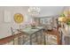 Cozy dining area featuring a modern chandelier and seamlessly connecting to the comfortable living space at 2174 Kent Ave, Clearwater, FL 33764