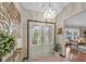 Inviting foyer showcasing decorative glass double doors and elegant light fixture at 2174 Kent Ave, Clearwater, FL 33764