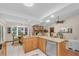 Open kitchen with stone fireplace, granite counters, stainless steel appliances, and breakfast nook at 2174 Kent Ave, Clearwater, FL 33764