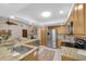Bright open kitchen with granite countertops, stainless steel appliances, and adjoining living area at 2174 Kent Ave, Clearwater, FL 33764