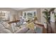 Open concept living room with hardwood floors, plush rug, and ample seating at 2174 Kent Ave, Clearwater, FL 33764