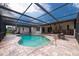 Beautiful backyard pool area with screened enclosure and brick patio at 2174 Kent Ave, Clearwater, FL 33764