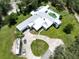Expansive aerial view showcasing the home's sprawling layout and the lush landscaping that surrounds the property at 21921 Us Highway 98, Dade City, FL 33523