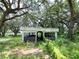 Rustic barn exterior with lush trees and greenery at 21921 Us Highway 98, Dade City, FL 33523