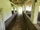 Interior view of the barn featuring aged concrete floor and weathered wooden ceiling at 21921 Us Highway 98, Dade City, FL 33523