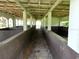 Interior view of the barn featuring aged concrete floor and weathered wooden ceiling at 21921 Us Highway 98, Dade City, FL 33523