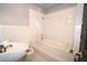 This bathroom showcases a tiled tub with shower, a sink, and a toilet at 21921 Us Highway 98, Dade City, FL 33523