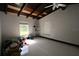 Bedroom with tile flooring, wood-beamed ceiling, and natural light from the window at 21921 Us Highway 98, Dade City, FL 33523