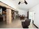 Open dining room area with tile flooring, decorative columns, ceiling fan and sliding glass doors at 21921 Us Highway 98, Dade City, FL 33523