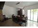 Dining room features a long wooden table with seating for ten, and an elegant lighting fixture at 21921 Us Highway 98, Dade City, FL 33523