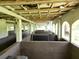 Interior view of the horse stalls with dividers and the exterior environment visible from within the structure at 21921 Us Highway 98, Dade City, FL 33523