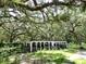 Exterior view of a horse stall surrounded by greenery and the shade from the trees at 21921 Us Highway 98, Dade City, FL 33523