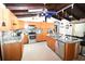 Spacious kitchen with wood cabinetry, granite countertops, stainless appliances and center island with barstools at 21921 Us Highway 98, Dade City, FL 33523