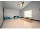 Bright living room features tile flooring, a ceiling fan, and a large window at 21921 Us Highway 98, Dade City, FL 33523