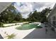 Backyard pool with surrounding patio, lush greenery, and ample space for outdoor enjoyment at 21921 Us Highway 98, Dade City, FL 33523
