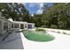 Backyard pool with surrounding patio, lush greenery, and ample space for outdoor enjoyment at 21921 Us Highway 98, Dade City, FL 33523