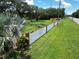 Overview of property line bordered by a white fence, complemented by a beautifully landscaped lawn at 21921 Us Highway 98, Dade City, FL 33523