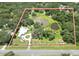 Aerial view displaying the entire property with serene ponds and lush greenery within the property boundary at 21921 Us Highway 98, Dade City, FL 33523