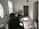 This is a mostly empty room with a door, chair, window, and miscellaneous items at 21921 Us Highway 98, Dade City, FL 33523
