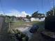 Exterior image of a large backyard featuring a trampoline, patio set, and a well-maintained lawn at 2509 Thornbrook Pl, Tampa, FL 33618