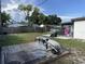 Spacious backyard with a full lawn, wooden fence, above ground pool, patio set, and a trampoline at 2509 Thornbrook Pl, Tampa, FL 33618