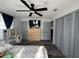 Bedroom featuring wood floors, a ceiling fan, desk, dresser, bed, and closet at 2509 Thornbrook Pl, Tampa, FL 33618