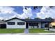 Inviting home with a covered carport, rocking chairs, and a lush green lawn at 2509 Thornbrook Pl, Tampa, FL 33618