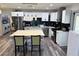 A modern kitchen features stainless steel appliances, white cabinetry, and a stylish center island at 2509 Thornbrook Pl, Tampa, FL 33618