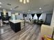 Open-concept living area featuring a central island, modern lighting, and comfortable seating at 2509 Thornbrook Pl, Tampa, FL 33618