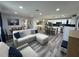 An open-concept living space with modern furnishings, a kitchen island and a dining area at 2509 Thornbrook Pl, Tampa, FL 33618