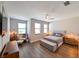Spacious bedroom with wood floors, a ceiling fan, and natural light from the windows at 2568 13Th N Ave # 2568, St Petersburg, FL 33713