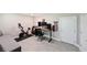 Spacious bonus room with a comfortable couch, exercise bike, and convenient desk area at 2568 13Th N Ave # 2568, St Petersburg, FL 33713
