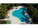 Aerial view of a beautifully landscaped community pool with plenty of lounge chairs at 2568 13Th N Ave # 2568, St Petersburg, FL 33713