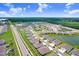 Aerial view showing the property near a pond, surrounded by a well-maintained neighborhood and green spaces at 31426 Ancient Sage Rd, Wesley Chapel, FL 33545