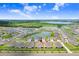 An aerial view showcases the property near a beautiful pond and lush green space in the surrounding community at 31426 Ancient Sage Rd, Wesley Chapel, FL 33545