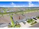 An aerial view shows the property, which features a two-car garage, manicured lawn and mature landscaping at 31426 Ancient Sage Rd, Wesley Chapel, FL 33545