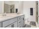 Bathroom featuring double sink vanity, modern fixtures, and a tiled shower at 31426 Ancient Sage Rd, Wesley Chapel, FL 33545
