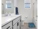 Bright bathroom featuring a single sink vanity with modern fixtures and hardware at 31426 Ancient Sage Rd, Wesley Chapel, FL 33545