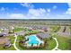 Aerial view highlights the community pool, clubhouse, playground, and well-manicured green spaces at 31426 Ancient Sage Rd, Wesley Chapel, FL 33545