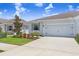 Charming home exterior features a well-manicured lawn, beautiful landscaping, and an attached two-car garage at 31426 Ancient Sage Rd, Wesley Chapel, FL 33545