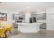Modern kitchen features gray cabinets, stainless steel appliances, a large island with bar seating, and a breakfast nook at 31426 Ancient Sage Rd, Wesley Chapel, FL 33545