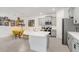 Modern kitchen featuring gray cabinets, stainless steel appliances, and a large island with breakfast bar, perfect for cooking at 31426 Ancient Sage Rd, Wesley Chapel, FL 33545