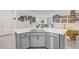 Modern kitchen with gray cabinets, stainless appliances, a large island with a sink, and an open layout at 31426 Ancient Sage Rd, Wesley Chapel, FL 33545