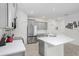 Modern kitchen with stainless steel appliances, gray cabinetry, and a large island with a white countertop at 31426 Ancient Sage Rd, Wesley Chapel, FL 33545