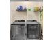 Laundry room with modern front loading washer and dryer at 31426 Ancient Sage Rd, Wesley Chapel, FL 33545