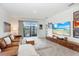 Bright living room with a modern entertainment center, large windows, and comfortable furniture, perfect for relaxation at 31426 Ancient Sage Rd, Wesley Chapel, FL 33545