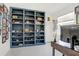Home office with a blue built-in bookshelf filled with camera and other collectibles at 31426 Ancient Sage Rd, Wesley Chapel, FL 33545